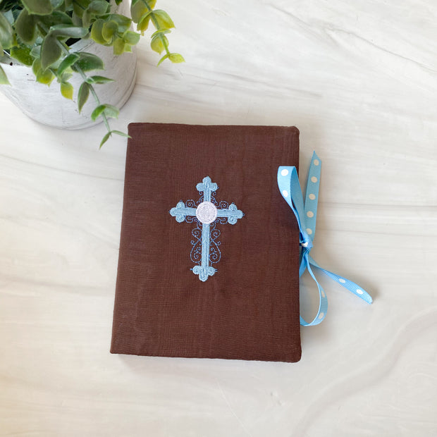 Brown album with Blue Cross